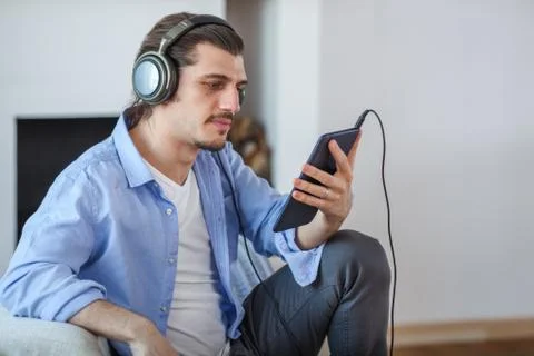 Handsome guy listening to music on internet with tablet Stock Photos