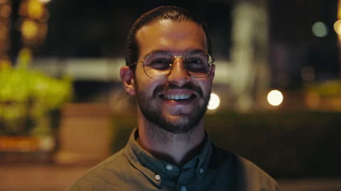 Handsome Guy Looking at Camera Standing in Night City Street. Close Up Stock Footage 246590465