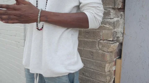Handsome Guy Looking Happy Standing Against A white Bricks Wall Vídeos de archivo 105360672