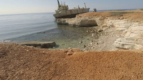 Handsome guy makes a selfie on the rocky seashore Stock Footage