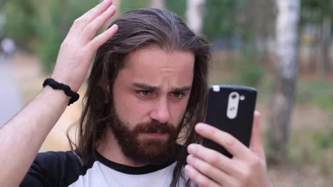 Handsome guy, a man straightens his hair. Stock Footage 120512972
