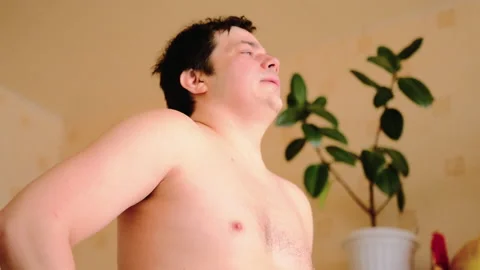 A handsome guy with a naked torso is resting after heavy exercise Stock-Footage 149552334