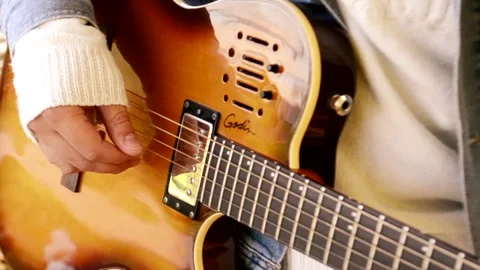 Handsome guy playing guitar in autumn Park Stock Footage 143834332