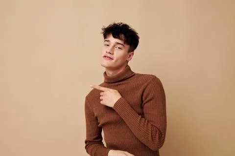 Handsome guy posing in brown sweater self confidence fashion isolated background Stock Photos