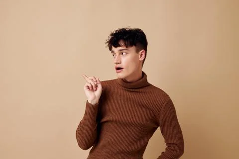 Handsome guy posing in brown sweater self confidence fashion isolated background Stock Photos
