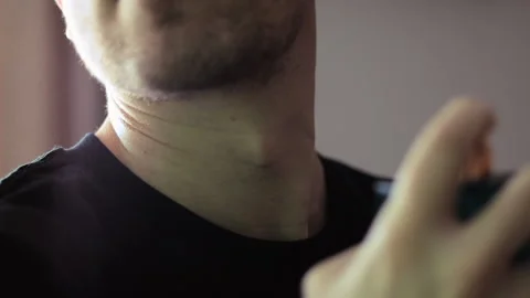 Handsome Guy Puts a perfume on His Neck Stock Footage 171730841