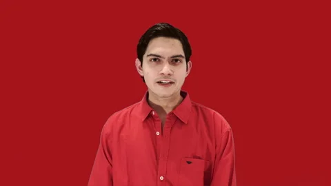 Handsome guy with red shirt and red background, 4K ProRes Stock Footage 164637892