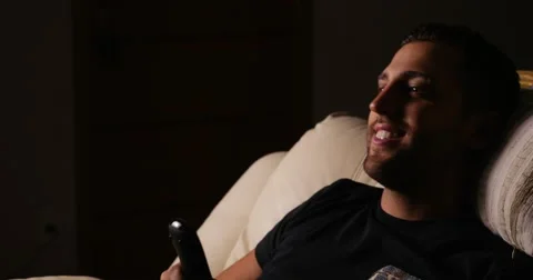 Handsome guy relaxing on the sofa Stock Footage 62358583