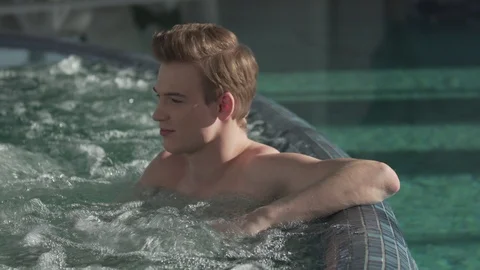 Handsome guy resting in the pool Stock Footage 127181259