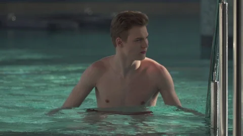 Handsome guy resting in the pool Stock Footage 127181300