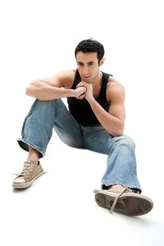 Handsome guy sitting on floor Stock Photos