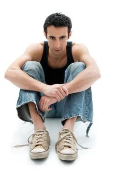 Handsome guy sitting on floor Stock Photos
