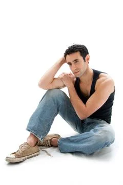 Handsome guy sitting on floor Stock Photos