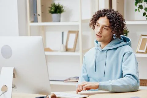 Handsome guy sitting in front of the computer work at home technologies Foto stock