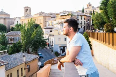 Handsome guy standing at sunset Stock Photos
