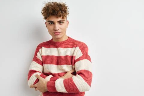 Handsome guy in a striped sweater posing isolated background Stock Photos