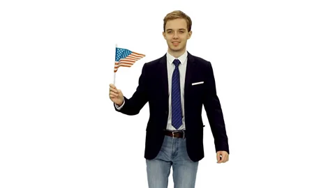 Handsome guy student in suit jacket walks with waving flag of USA, alpha in Stock Footage 123150682