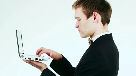 Handsome guy in a suit is typing on a laptop. Vídeo Stock 59311375
