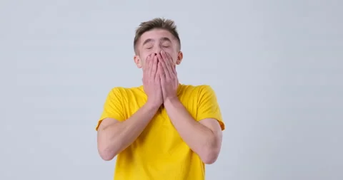 Handsome guy surprised to camera on white background Stock Footage 144958077