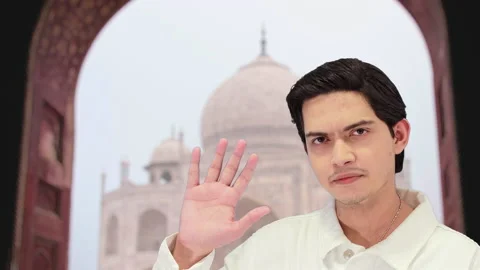 Handsome guy with taj mahal background, 4k Video stock 164329094