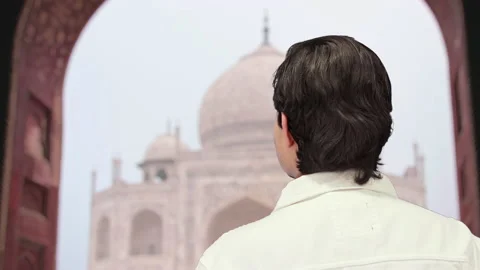Handsome guy with taj mahal background, 4k Stock Footage 164329375