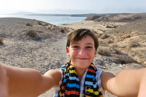 A Handsome guy taking a selfie on the beach during his summer vacation Stock Photos