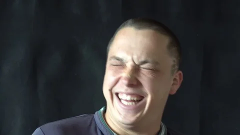 Handsome guy talking and laughs to camera Stockbeeldmateriaal 75531863