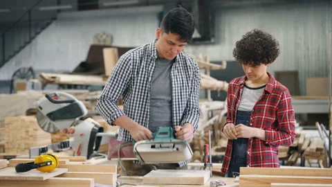 Handsome guy teaching new worker apprentice to use polishing machine at factory Video stock 113745144