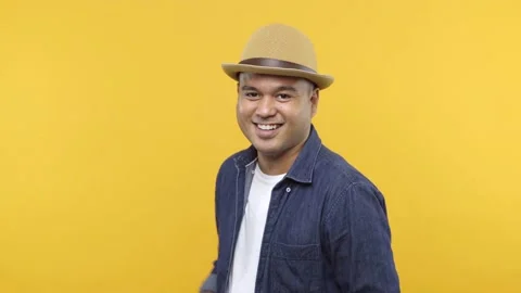 A handsome guy turning around and lift his hand point into camera with smile, se Stock Footage 144662400