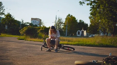 Handsome Guy Type a Message Standing Near a Bicycle at Sunset. Stock Footage 80008265