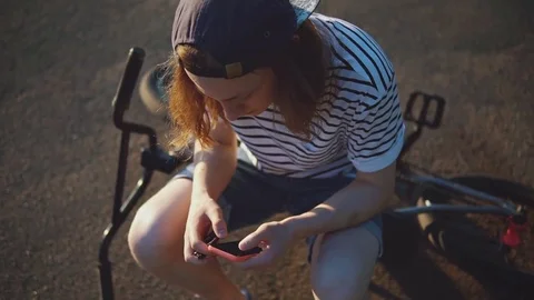 Handsome Guy Type a Message Standing Near a Bicycle at Sunset. Stock Footage 80008419