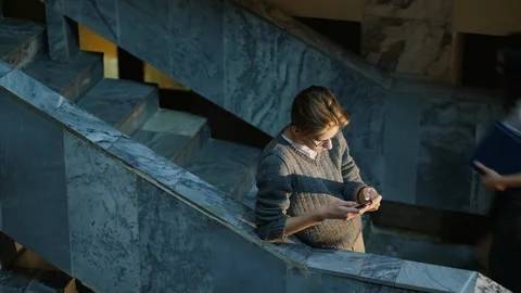 Handsome guy uses a smartphone Stock Footage 125420628