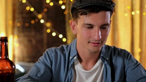 Handsome guy is using a digital tablet while sitting at the bar counter in pub Stock Footage 122014208
