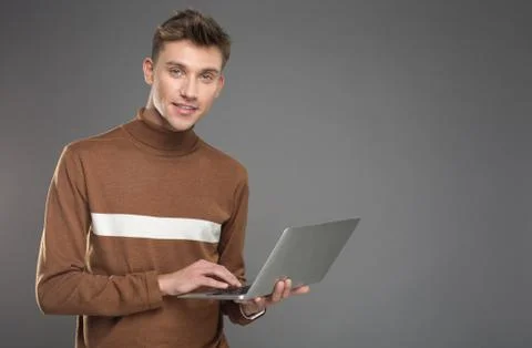 Handsome guy using gadget with joy Foto stock