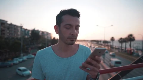 Handsome guy using mobile phone and then looking Stock Footage 112894261