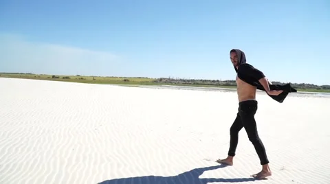 Handsome guy walking in the desert Stock Footage