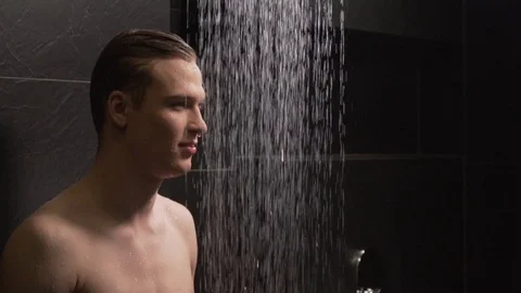 Handsome guy washes in the shower Stock Footage 127153191