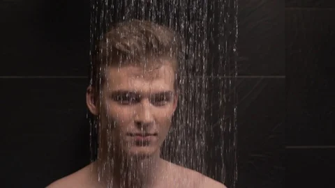 Handsome guy washes in the shower Stock Footage 127153494