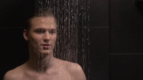 Handsome guy washes in the shower Stock Footage 127153711