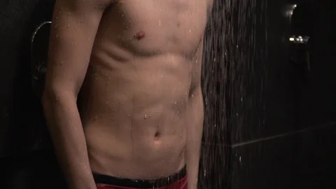 Handsome guy washes in the shower Stock Footage 127153779