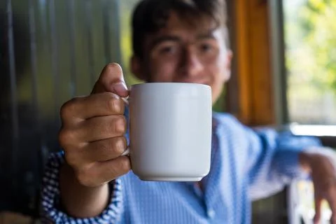 Handsome guy with white cup of tea. Usefull also as template. Stock Photos