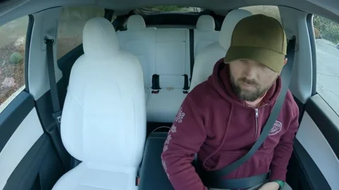 Handsome guy yawns while driving fast eco friendly electric car, Train AI TESLA Stock Footage 237403350