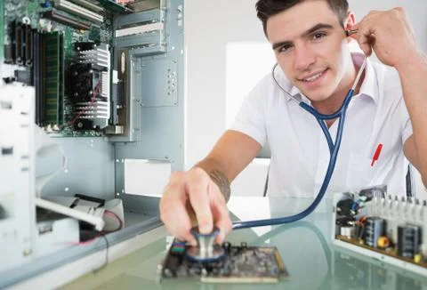 Handsome happy computer engineer holding stethoscope Stock Photos