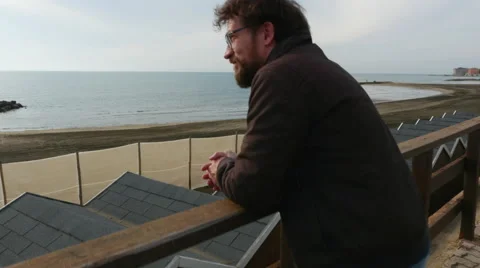Handsome happy man looking beach winter moving camera dolly shot Stock Footage 58411543
