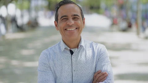 Handsome happy man looking at camera outdoor Stock Footage 107804080