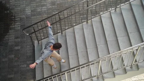 Handsome happy man running, smiling and dancing with happiness climbing stairs Stock Footage 140211853