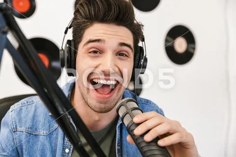 Handsome happy young male radio host broadcasting Stock Photos