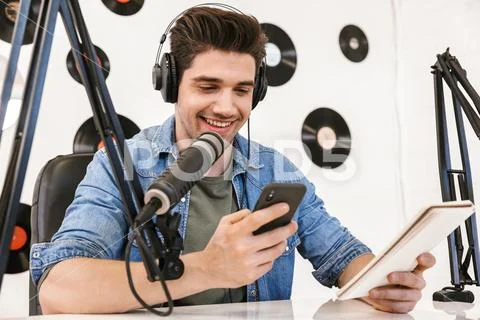 Handsome happy young male radio host broadcasting Stock Photos