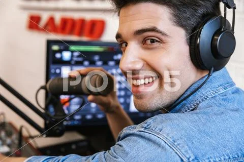 Handsome happy young male radio host broadcasting Stock Photos