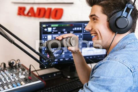 Handsome happy young male radio host broadcasting Stock Photos